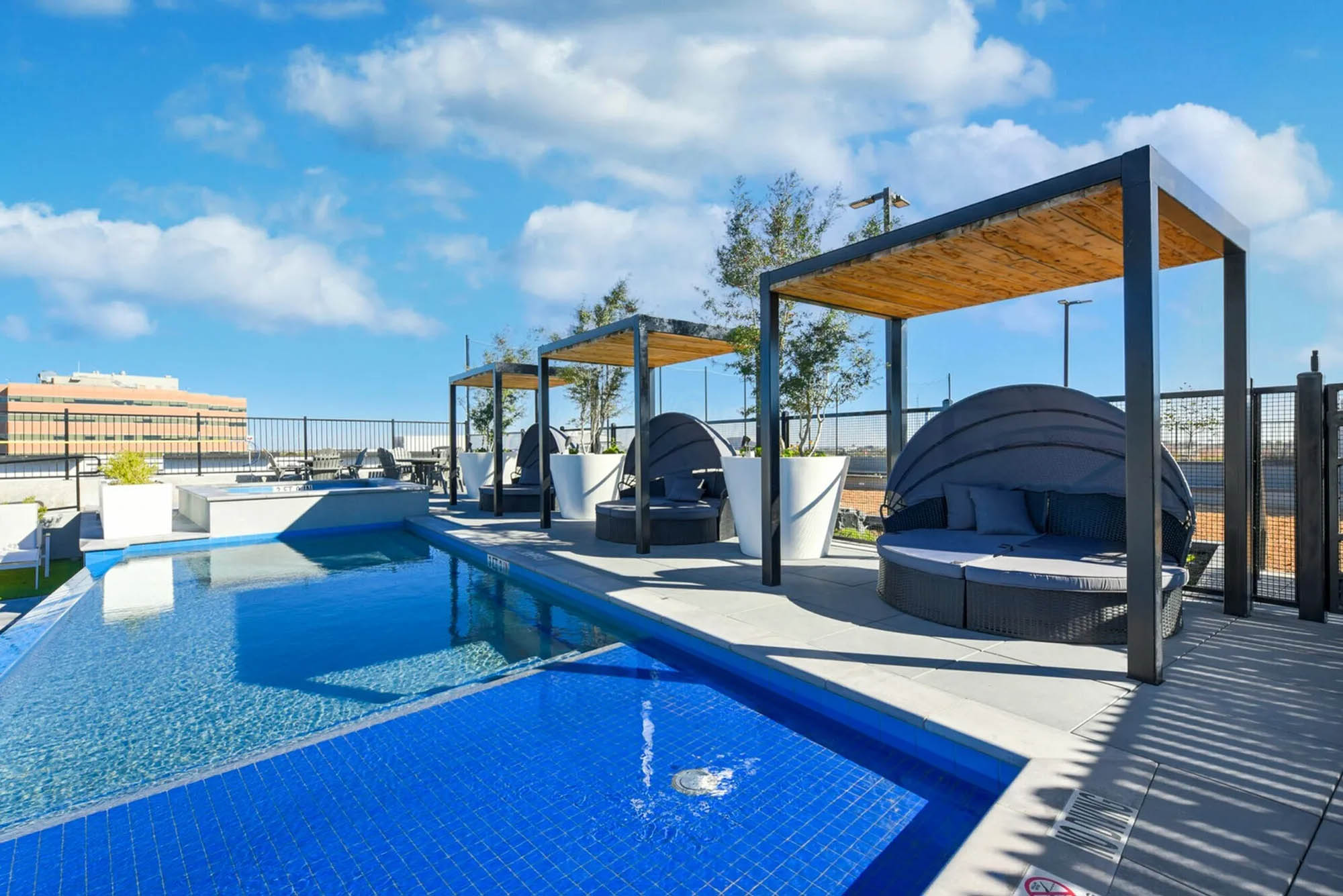 Cabanas and upscale pool seating near hot tub and infinity pool