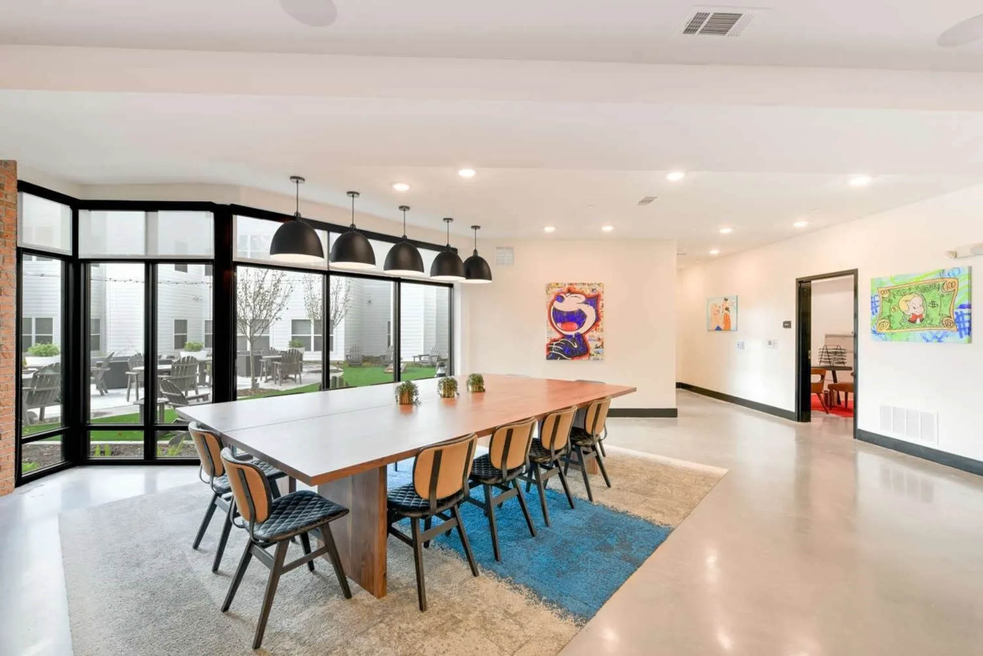 Conference tablr in a clean minimal space with gallery style art hangings