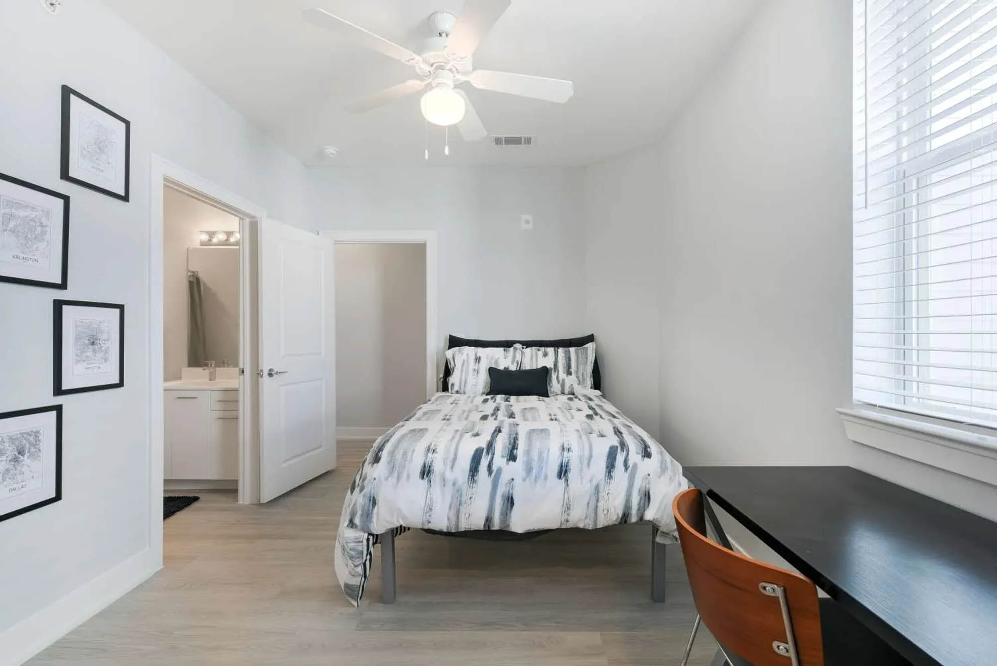 Modern bed in a clean spacious bedroom with desk