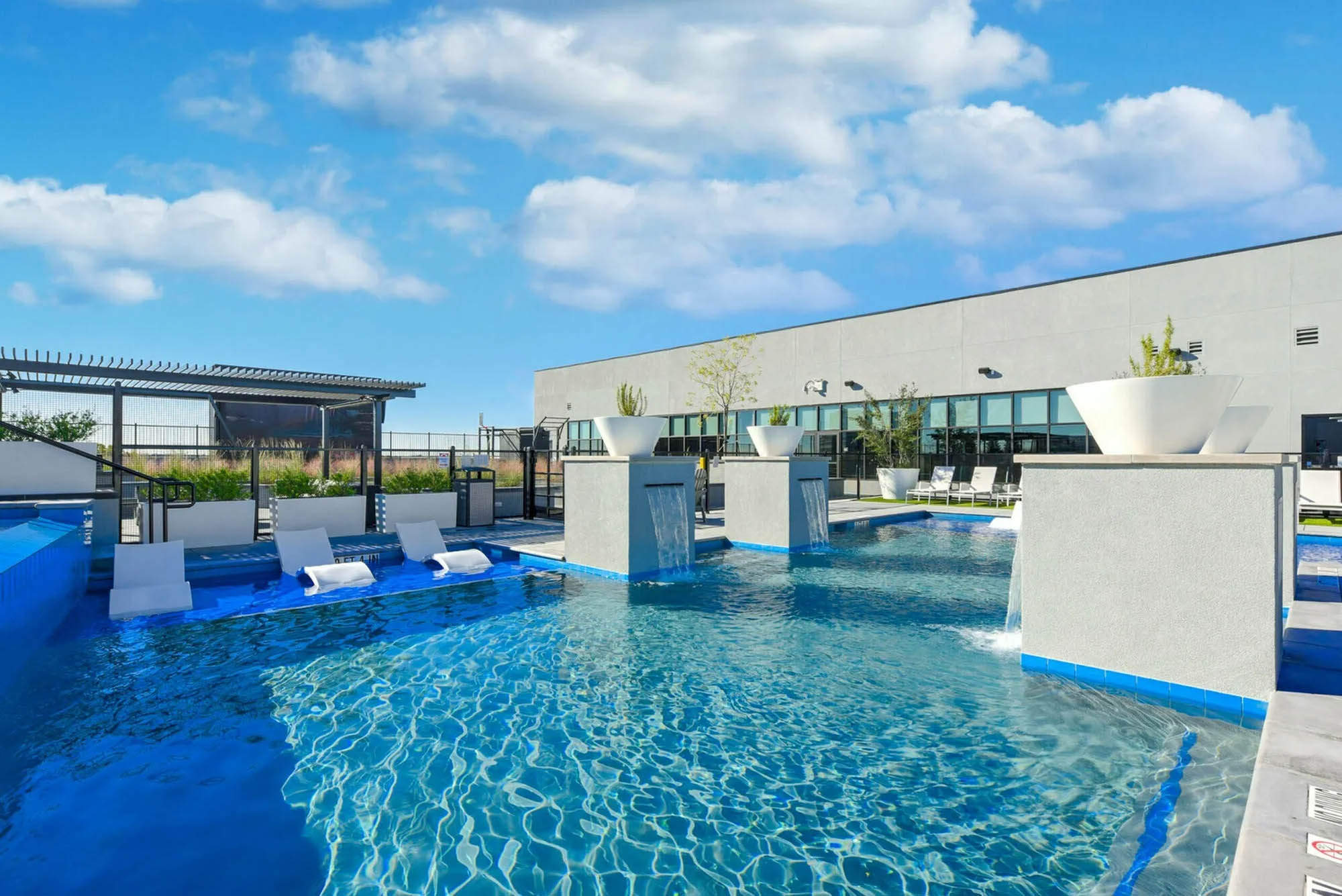 Resort style pool with waterfalls and in pool seating