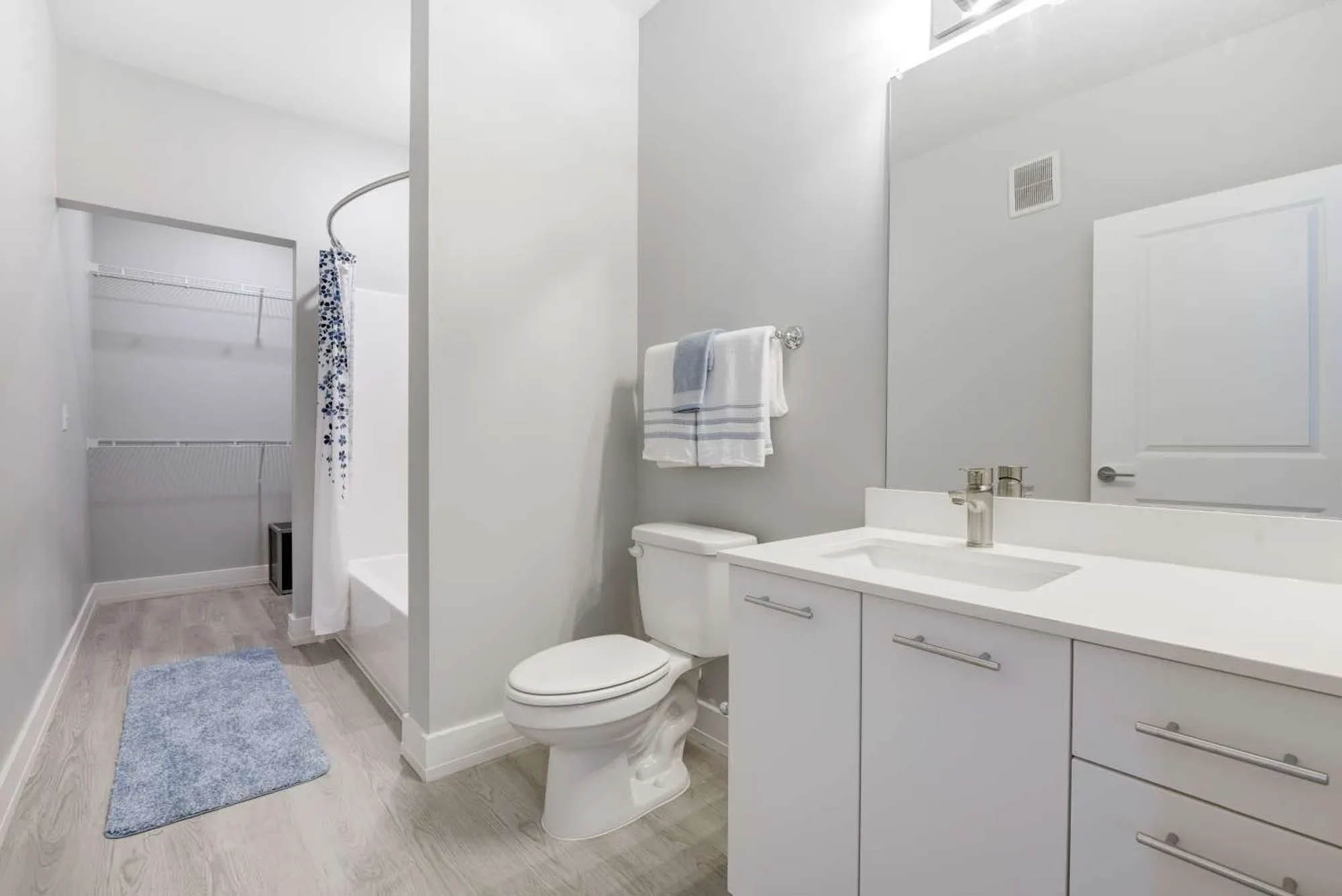 Spacious light grey bathroom with ample counter space